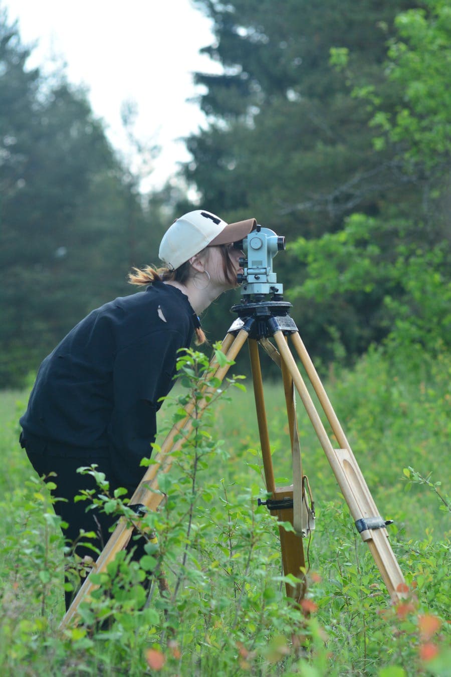 Surveyor with total station performing a topographic survey on a Dubai site